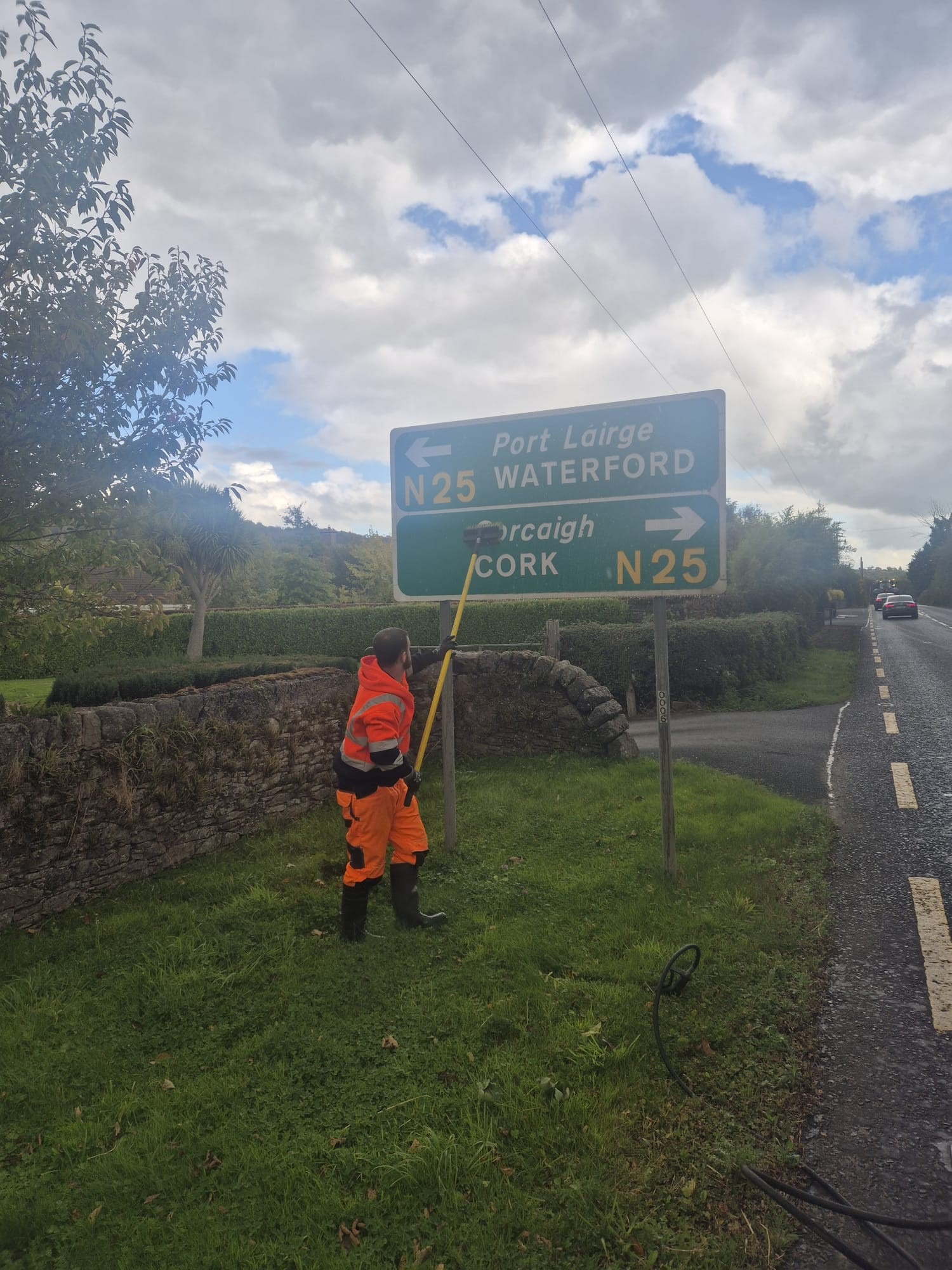 Washing the face of a sign to make it readable again.